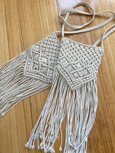 Intricately, handcrafted, made with love and attention to detail, these macrame cross body bags are a must accessory to add a little life to your outfit. With stylish tassel accents, they make a wonderful gifts for the everyday women to elevate their style. Linen lining inside with pockets to store your mobile and a zipped pocket for the little secure items you wish to store. Two options available, both are the same pattern on front and back and both are the same on the inside. The one pictured left is a slightly shorter and darker version with a little love heart zipper. The one pictured right is longer and has a standard zipper. Please see last photo for dimensions and make sure to select either A or B at checkout. It is made from durable cotton rope and is 100% handmade by high quality Macrame Crossbody Bag For Beach, Handmade Bohemian Shoulder Bag With Adjustable Strap, Bohemian Crochet Crossbody Bag With Braided Handles, Bohemian Handmade Adjustable Shoulder Bag, Bohemian Crochet Tote Bag With Macrame, Bohemian Beige Crochet Bag With Adjustable Strap, White Bohemian Crochet Bag With Adjustable Strap, Beige Bohemian Crochet Crossbody Bag, Bohemian Beige Crochet Crossbody Bag