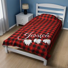 a bed with a red and black checkered comforter