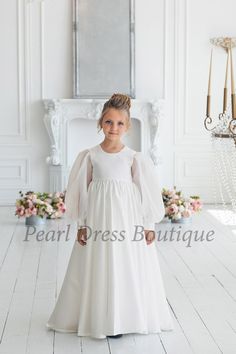 This satin flower girl dress is a floor-length gown designed to create a timeless and elegant look. The dress features delicate organza sleeves that add a touch of grace, while the closed back provides a modest and classic silhouette. With its high waistline, this gown enhances the figure and brings a regal charm to any special occasion, making it perfect for weddings, formal events, or other celebrations See more flower girl dresses in my store: https://www.etsy.com/shop/PearlDressBoutique?ref= Mini Bride Dress, Satin Dress Long Sleeve, Long Sleeve Flower Girl Dress, Mini Bride, Kids Formal Dresses, Baby In Wedding Dress, Satin Dresses Long Sleeve, Holy Communion Dresses, Satin Flower Girl Dress