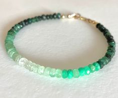 Natural raw emerald gemstones in ombré pattern of very dark to pale green. 4mm faceted rondelles beaded with choice of 14k gold fill or .925 sterling silver clasp and findings. Dainty beaded bracelet made to order. Please add 1/2 to 3/4 inch to your actual wrist measurement for a comfortable fit.