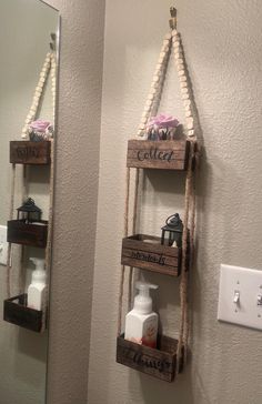 two wooden shelves with soap and lotion on them hanging from the side of a wall