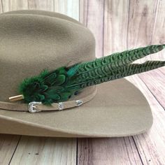 Fixes to hat with pin and rubber backing. Western Green Hat Bands For Kentucky Derby, Green Western Hat Bands For Kentucky Derby, Western Mini Hat With Feathers For Country Events, Western Mini Hat With Feathers For Rodeo, Hat Customization, Feather Bow Ties, Hat Bar, Green Feather, Feather Hat