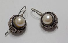 "Vintage sterling 925 & pearl earrings. 7.5mm pearl encased in a sterling frame signed 925NV. 1\"L with ear wires. Excellent condition. Classic! Gorgeous!!" Vintage Silver Round Pearl Earrings, Classic Handmade Pearl Earrings For Formal Occasions, Handmade Silver Pearl Earrings For Formal Occasions, Formal Sterling Silver Nickel-free Pearl Earrings, Formal Sterling Silver Pearl Earrings Nickel Free, Formal White Gold Pearl Earrings Nickel-free, Formal White Gold Pearl Earrings Nickel Free, Giraffe Ring, Hand Bells