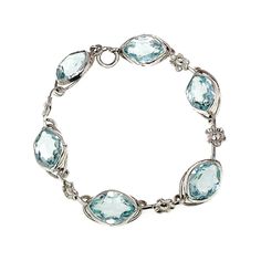 Indulge in the allure of the 1910s with this exquisite light blue glass flower bracelet delicately crafted from sterling silver. Embrace the timeless beauty of this piece and elevate your style with a touch of vintage elegance. The bracelet is in very good vintage condition with minimal signs of wear. The surface of the silver has fine lines and marks, but nothing noticeable or obvious. The glass is not chipped or cracked and secure in the settings. The spring ring clasp is fully functional, and Elegant Aquamarine Silver Bracelets, Elegant Aquamarine Bracelet Jewelry, Elegant Blue Aquamarine Bracelets, Elegant Light Blue Aquamarine Bracelet, Elegant Blue Topaz Bracelet, Delicate Blue Jewelry For Formal Occasions, Adjustable Light Blue Formal Jewelry, Elegant Turquoise Oval Sterling Silver Bracelet, Elegant Turquoise Gemstone Sterling Silver Bracelet