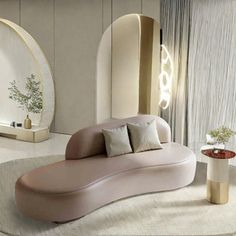 a modern living room with an oval shaped couch and round mirror on the wall behind it