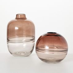 two brown and white vases sitting next to each other