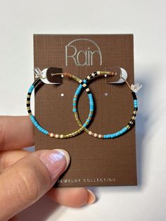 Discover the perfect balance of elegance and playfulness with our Gold Blue Mix Tiny Bead Hoop Earrings! The delicate gold hoops are adorned with tiny blue beads, adding a pop of color to any outfit. Elevate your style and make a statement with these unique and eye-catching earrings. Gold Beaded Small Hoop Earrings For Summer, Trendy Small Hoop Beaded Earrings, Nickel Free Small Hoop Beaded Earrings In Trendy Style, Gold Hoop Earrings With Tiny Beads For Summer, Adjustable Small Hoop Earrings In Blue, Colorful Beaded Hoop Earrings For Everyday Summer, Blue Beaded Earrings For Everyday, Adjustable Small Blue Hoop Earrings, Trendy Small Blue Hoop Earrings