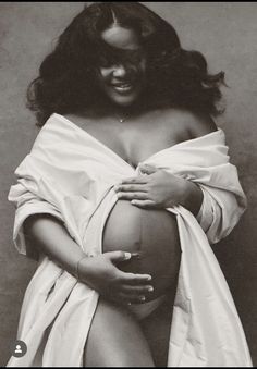 a black and white photo of a pregnant woman