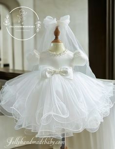 ♥ WHITE WEDDING DRESS This adorable tutu style dress is perfect for Birthdays, Photos, or just for dress up. Tutu dresses photograph beautifully. The tulle holds its shape and the top is very soft and stretchy. These dresses are light and easy to play in. The dress bottom has layers of tulle and a halter strap that makes this dress easy to wear. We certainly want to make sure your princess gets a perfect fit! ☛ Product Name: White Tulle Dress ☛ Product Type: Handmade ☛ Product Material: Tulle, S Fitted Tutu Dress With Bow For Baptism, Fitted Tulle Baptism Dress With Bow, Fitted Tutu Dress With Bow For Wedding, Fitted White Tutu Dress With Bow, White Fitted Tutu Dress With Bow, Elegant Tutu Dress With Bow For Baptism, Princess Style Fitted Tutu Dress For First Communion, Elegant Baptism Tutu Dress With Bow, Fitted Princess Tutu Dress For First Communion