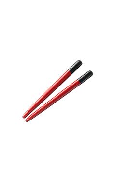 two red and black chopsticks on a white background