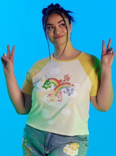 Channel some Funshine Bear vibes to your wardrobe! This sunny baby tee features a vintage print of classic Care Bears hanging out on rainbows and clouds ready for another fun day in Care-A-Lot! This skimmer length top has yellow raglan detailing along the sleeves and collar. Care Bears Rainbow, Kidcore Fashion, Funshine Bear, Plus Size Hot, Her Universe, Cali Girl, Plus Size Fits, Care Bear, Comfy Sweaters