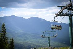 people ride the gondola at the top of a mountain