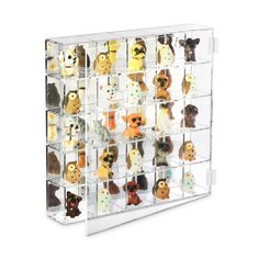 an acrylic display case filled with lots of small stuffed animals on white background