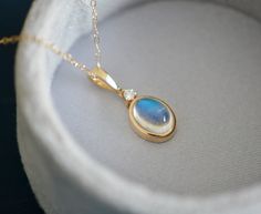 This ones a beauty! Gorgeous rainbow moonstone is set in 14k gold with a diamond accent. This dainty pendant is great for when you want to dress up and is a great choice for anyone who appreciates handcrafted design and genuine gemstones. * Pictured product has a stone size of 8x6mm Metal : 14kt Gold Gemstones : Rainbow Moonstone (choose size from dropdown), Diamond Moonstones Rainbow Moonstone acts as a prism, diffusing energy throughout the aura. It is said to provide psychic protection, clear Oval Moonstone Necklace In Yellow Gold, Dainty Pendant Necklace, Psychic Protection, Dainty Pendant, Blue Moonstone, June Birthstone, Moonstone Jewelry, June Birth Stone, Gold Pendant Necklace