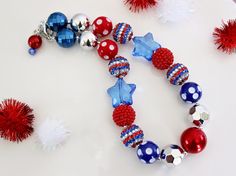 "Featuring striped rhinestone beads, and a Patriotic color palette of red, silver and blue, this beautiful beaded necklace has a distinctly All-American look. Would be the perfect accessory for a Memorial Day or 4th of July outfit! More patriotic styles can be found in my 4th of July section: https://www.etsy.com/shop/ChunkyStuffByLBB?ref=seller-platform-mcnav&section_id=17113232 ✔ Necklaces come in child to adult sizes with a 2\" extender chain and jumbo lobster clasp for easy fastening. Since Beautiful Beaded Necklaces, Patriotic Fashion, 4th Of July Outfits, Necklace Red, Matching Bracelet, Rhinestone Bead, Chunky Necklace, Small Frame, Matching Bracelets