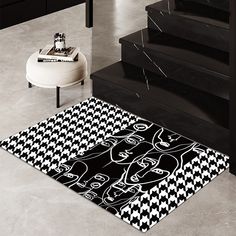 a black and white area rug on the floor next to stairs with an image of a woman