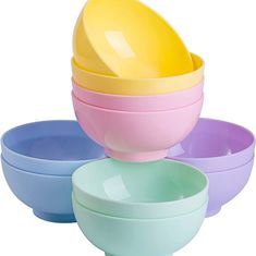 four bowls are stacked on top of each other with one yellow egg in the middle