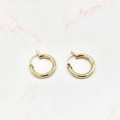 Handcrafted in 14k yellow gold, these hoops are great for everyday wear since they are lightweight. They are plain and can be stacked with other mini hoops or Huggies. They can be worn in the shower, at the gym, and while swimming and do not need to be taken off. They are simple, yet elegant at the same time. These hoops come with a hinged back lock and tube-liked design. 14k hollow yellow gold XXS: Hoop Diameter: 18mm, Thickness: 3mm ﻿﻿All measurements are approximate If you need help picking t Small Yellow Gold Stackable Hoop Earrings, Stackable Yellow Gold Hoop Huggie Earrings, Stackable Yellow Gold Huggie Hoop Earrings, Gold Stackable Hoop Earrings For Everyday, Yellow Gold Stackable Hoop Huggie Earrings, Everyday Yellow Gold Small Hoop Earrings, Yellow Gold Small Hoop Earrings, Minimalist Stackable Yellow Gold Hoop Earrings, Minimalist Yellow Gold Stackable Hoop Earrings