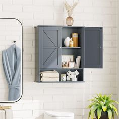 a white toilet sitting next to a gray cabinet