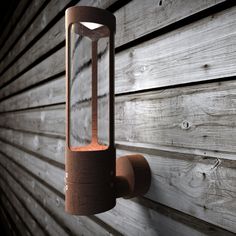 a wall mounted light on the side of a wooden building