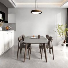 a table and chairs in a room with white walls