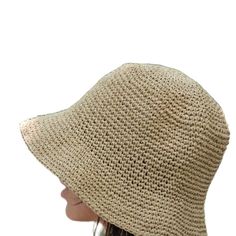 This hat is 100% handmade and crafted from raffia yarn. Raffia yarn is a natural and durable material, ensuring the hat's longevity. The wide brim of the hat is perfect for sun protection and offers a stylish look. This beige hat stands out with its simple and elegant design. It is an excellent accessory for both everyday use and outdoor activities like the beach. Its comfortable and lightweight structure ensures easy and prolonged wear. Raffia. You can store this hat, knitted from raffia rope, in a breathable cloth bag, protect it from fire and heat, and wipe the stains with a clean damp cloth. Eco-friendly Toquilla Straw Hat, Natural Wide Brim Toquilla Straw Bucket Hat, Handwoven Beige Brimmed Bucket Hat, Beige Toquilla Straw Bucket Hat With Flat Brim, Natural Handwoven Bucket Hat With Curved Brim, Beige Woven Panama Hat With Curved Brim, Beige Handwoven Wide Brim Bucket Hat, Beige Wide Brim Handwoven Bucket Hat, Natural Woven Wide Brim Bucket Hat