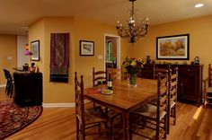 a dinning room table with chairs and a chandelier