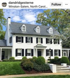 a large white house with black shutters