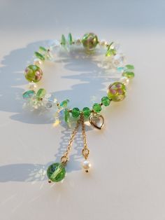 This beautiful green bracelet is very suitable for daily wear. It can also be given to girlfriends, daughters, mothers, or as a birthday gift to friends Main materials: Beads Size: My bracelets are elastic bracelets, the size of the bracelets is a little under 6.5inches without stretching, so they can be suitable for most people's wrist. It is elastic so if you need a bigger size, it is important to consider that it does stretch. Green Jewelry With Heart Charm And Round Beads, Elegant Green Beaded Charm Bracelet, Elegant Green Heart-shaped Bracelet, Elegant Green Charm Bracelet With Round Beads, Fairy Core Bracelets, Handmade Green Heart-shaped Bracelet, Green Charm Bracelet With Colorful Beads As Gift, Green Heart Beads Bracelet Jewelry, Green Adjustable Crystal Bracelet For Gift