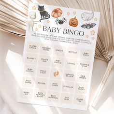 a baby shower game with pumpkins, bats and cats on it next to a fan