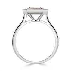 a white gold ring with a square shaped diamond in the center