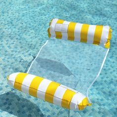 an inflatable raft sitting on top of a swimming pool next to a yellow and white buoy