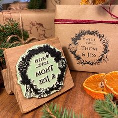 an orange slice and some wrapping paper on a wooden table next to two boxes filled with gifts