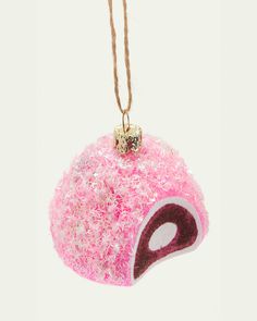 a pink ornament hanging from a string