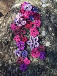 Beautiful floral garland scarf in pink, burgundy and lavender. Made from an assortment of yarns with complimentary colours and textures. This  scarf will make a pretty and delicate addition to your spring and autumn wardrobe. Its lacy, floral forms will transition seamlessly from casual to dressy, equally at home with jeans or something more dressy. Pink Crochet Bohemian Scarf, Pink Bohemian Crochet Scarves, Pink Crochet Bohemian Scarves, Bohemian Pink Crochet Scarves, Bohemian Pink Crochet Scarf, Handmade Purple Scarves As Gifts, Handmade Purple Scarves For Gifts, Complimentary Colours, Scarf Lace