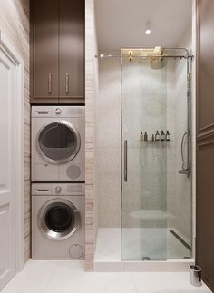 a washer and dryer in a bathroom with brown cabinetry on the walls