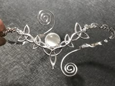 I've fabricated a truly Celtic upper arm cuff bracelet, or arm torc, in Celtic fashion with an 8mm round Moonstone shown for reference, but you can choose a myriad in the drop down menu. I designed this piece in sterling silver and an approximate size for the piece will fit most arm sizes, as you can squeeze it on for a secure fit. There's a total of 5 Trinity Knots that wonderfully matches this wedding circlet: https://www.etsy.com/listing/181351917/celtic-wedding-bridal-headpiece-circlet?ref=s Pretty Silver Bracelet, Silver Arm Jewelry, Silver Fantasy Jewelry, Arm Cuff Jewelry Silver, Fantasy Style Silver Jewelry With Unique Design, Adjustable Wire Wrapped Fantasy Jewelry, Fantasy Style Silver Bracelet, Adjustable Silver Fantasy Bracelet, Silver Fantasy Bracelet