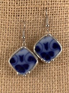 These Antique Chinawear earrings were created from a chipped flow blue platter that was produced in England.  The earrings measure approximately 7/8" square on point.  A pretty floral pattern is depicted.  The ear wires are hypoallergenic surgical steel.  Sterling wires are available on request. Normally I find the unique antique china items that I utilize for jewelry at antique shows and shops. Each design is cut on a porcelain/tile saw, shaped on a grinder, and finished with a silver solder be Vintage Blue Hypoallergenic Earrings, Blue Rectangular Earrings With Ear Wire, Blue Rectangular Earrings, Blue Hypoallergenic Vintage Earrings, Blue Square Earrings For Gift, Tile Saw, Antique Show, Broken China, Flow Blue