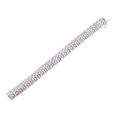 Exquisite 13ctw G/VS diamond bracelet in 18k white gold. DESIGNER: Not Signed MATERIAL: 18k Gold GEMSTONES: Diamond DIMENSIONS: Bracelet is 6 5/8" long and 11.5mm wide. Thickness 8.7mm. MARKED/TESTED: 750, 3583AL. WEIGHT: 59 grams CONDITION: Previously Owned/Excellent Condition White Diamond Bracelet With Jubilee Design, White Platinum Diamond Jubilee Bracelet, White Platinum Jubilee Diamond Bracelet, Silver Diamond Jubilee Bracelet In Platinum, Silver Bracelets With Baguette Diamonds, Dazzling Silver Diamond Bracelet In Platinum, White Wedding Diamond Bracelet With Baguette Diamonds, Silver Bracelets With Baguette Diamonds For Wedding, Silver Baguette Diamond Tennis Bracelet For Wedding