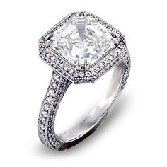 an engagement ring with a cushion cut diamond in the center