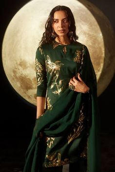 Emerald green kurta with gold floral foil print and sequin work on hem. Paired with palazzo and scallop bordered dupatta.
Component: 3
Pattern: Foil Print
Type Of Work: Floral, sequin
Neckline: Keyhole
Sleeve Type: Three quarter
Fabric: Kurta and Pant: Silk Chanderi, Dupatta: Organza, Lining: 100% Cotton
Color: Green
Other Details: 
Scallop bordered dupatta
Weight (in gms): 600
Occasion: Sangeet - Aza Fashions Straight Kurta Palazzo Set With Gold Embroidery For Festivals, Unstitched Suit With Gold Embroidery For Designer Wear, Green Anarkali Set With Gold Embroidery, Green Sets With Gold Embroidery For Eid, Festive Green Sets With Gold Embroidery, Green Salwar Kameez With Unstitched Blouse, Green Anarkali With Gold Embroidery, Palazzo Set With Gold Embroidery And Straight Kurta, Gold Embroidered Saree Set