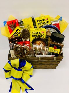 a basket filled with lots of different types of food next to a yellow and blue ribbon