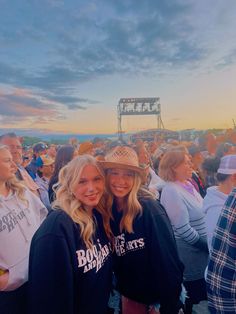 two women standing next to each other in front of an audience at a music festival