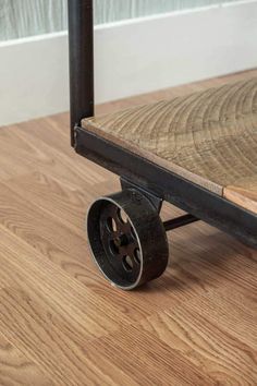 the wheels on this dolly are made from wood and metal, with black spokes