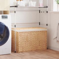 a washer and dryer sitting next to each other in a room with wooden floors