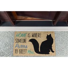 a door mat that says home is where someone purrs to greet you on it