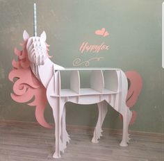 a pink and white horse shaped desk in front of a wall with the words happy valentine written on it