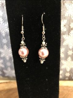 * Lt Peach Medium (approx 8mm) Size Faux Pearl Earrings With Gold Tone Accents * This is a one of kind design but variable in color and bead size. * Can change Eurowires from gold tone to silver plated or vs/vs * Eurowires are nickle free * Ready to ship 3-5 business days except for custom orders. Please contact for details * Ships from DeKalb, Illinois  BaublesNBeadedThings has created these beaded earrings as an original work not constructed using any tutorials or methods that may be patented. The designs of earrings sold in BaublesNBeadedThings' shop are the intellectual property of BaublesNBeadedThings and do not violate any patents. For additional information, please contact us at: lindasbaublesnbling at gmail.com  NO SHIPPING OUTSIDE OF UNITED STATES. Handmade Pink Pearl Earrings, Handmade Pink Round Pearl Earrings, Pink Pearl Drop Round Earrings, Pink Pearl Round Earrings, Pink Pearl Drop Jewelry With Round Beads, Pink Pearl Jewelry With Ear Wire, Pink Pearl Earrings With Round Ear Wire, Pink Round Pearl Earrings With Ear Wire, Elegant Pink Beaded Earrings For Gift