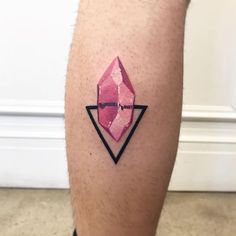 a man's leg with a pink diamond tattoo on it