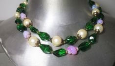 Add a pop of vintage glamour to your outfit with this stunning Trifari necklace from the 50s! Featuring opalescent glass and imitation pearls in a gorgeous emerald green hue, this 18-inch beaded piece is signed and original. Perfect for any fashion-forward woman who loves unique, timeless jewelry. #VintageFashion #TrifariJewelry #EmeraldGreen #OpalescentGlass #ImitationPearls #NecklaceLove #eBaySeller #Glass #Pearl #Necklace #Trifari #Beaded #Emerald #ImitationPearl #Women #Fashion Green Glass Necklace For Party, Vintage Glass Beaded Necklaces For Party, Vintage Green Glass Beaded Necklaces, Green Vintage Glass Beaded Necklaces, Handmade Retro Green Jewelry, Vintage Green Round Beads Jewelry, Vintage Green Round Bead Jewelry, Retro Green Beaded Necklace For Gift, Vintage Adjustable Green Necklace